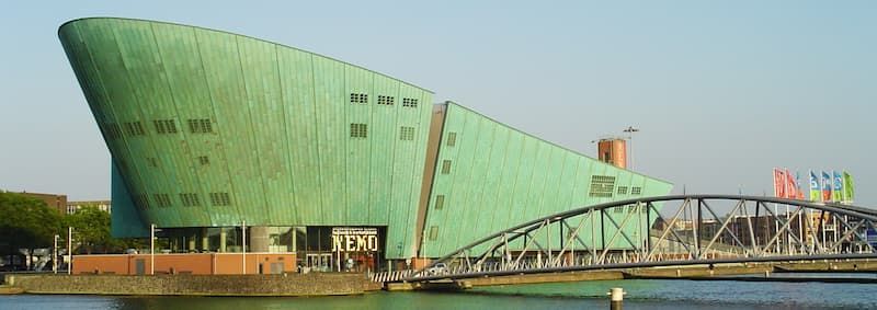 Fotografia dell'esterno del Museo della scienza NEMO di Amsterdam progettata da Renzo Piano. La struttura somiglia ad una grande nave metallica di colore verde